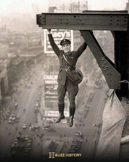 A New York City police officer poses hanging over Times Square, 1920.Buzz 📔 History