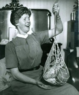 The photograph shows nurse Catriona MacAskill weighing a baby. The photograph was taken in 1959 in North Uist, Scotland.Time Machine | Historical Photo