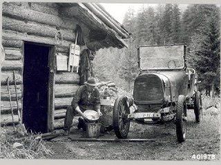 A gold miner washes gold in his shack.Time Machine | Historical Photo