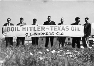 Members of an oil workers' union display a banner with the message "Boil Hitler ...